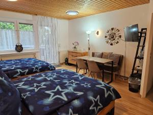 a bedroom with a bed and a table and a dining room at Pension Haus Erika in Cuxhaven +65 photos