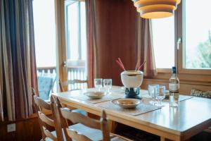 a dining room table with glasses and a bottle of wine at Chalet Engihalde in Amden