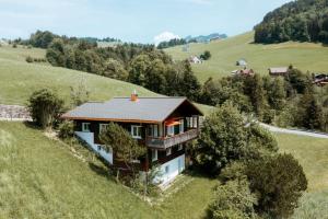 an aerial view of a house in a field at Chalet Engihalde in Amden