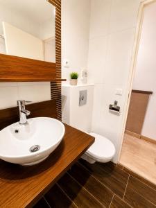 a bathroom with a sink and a toilet at Appart Omaha Beach in Port-en-Bessin-Huppain