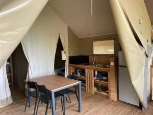 a dining room with a table and chairs in a tent at lodge lavallee in Belvédère +18 photos