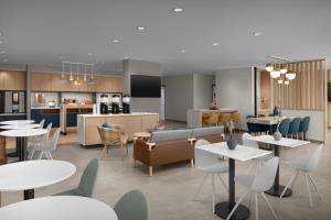 a rendering of a restaurant with tables and chairs at TownePlace Suites by Marriott Palmdale in Palmdale