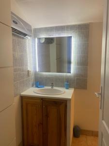a bathroom with a sink and a mirror at Le bleu des toits in Lodève