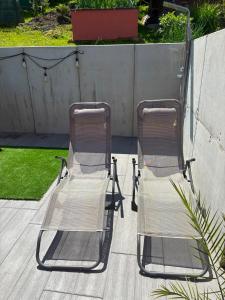 two lawn chairs sitting next to each other on a patio at Penzion Ján in Habovka