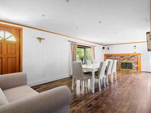 a dining room with a table and chairs and a fireplace at Beautiful 6-Bedroom Escape Featuring a Private Pool in Hampton Bays