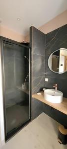 a bathroom with a sink and a mirror at Clos De La Ronziere Avec Jacuzzi in Soulages
