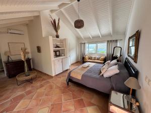 a bedroom with a large bed in a room at Villa Joëlle in Anse Marcel 
