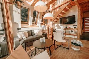 a living room with a couch and a table at Duh šume in Kupjak