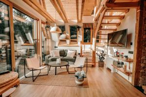 a living room with a couch and a table at Duh šume in Kupjak