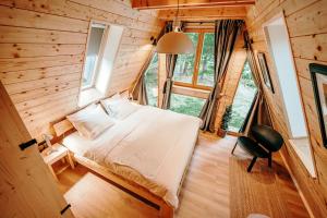 a bedroom with a bed in a wooden cabin at Duh šume in Kupjak