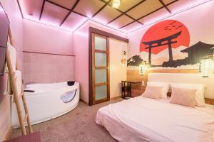 a bedroom with a bed and a bath tub at Le Bain de Sakura - Hypercentre in Marseille