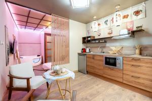a kitchen with a sink and a table in a room at Le Bain de Sakura - Hypercentre in Marseille