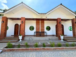 a white house with a brick at Bunohan Villa Roomstay in Tumpat