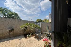 a patio with a stone fence and plants at Leonaldo's Farm and Staycation in Kinalaglagan
