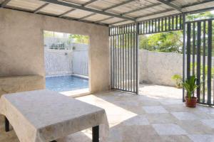 a patio with a table and a swimming pool at Leonaldo's Farm and Staycation in Kinalaglagan