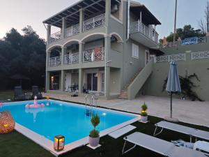 a house with a swimming pool in front of a house at Loukas House 2 Κέρκυρα Σταυρός Μακράτα in Stavrós