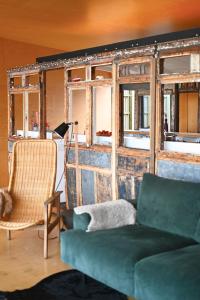 a living room with a couch and a chair at El Ray by Bloom Stays in Dungeness