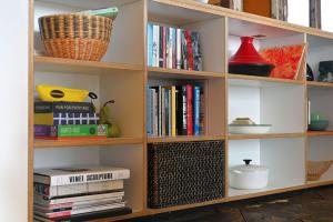 a book shelf filled with books and books at El Ray by Bloom Stays in Dungeness