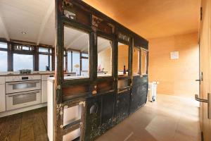 a kitchen with an old wooden cabinet in a room at El Ray by Bloom Stays in Dungeness +28 photos