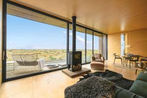 a living room with a fireplace and a view of the desert at El Ray by Bloom Stays in Dungeness