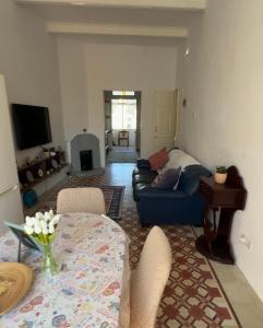 a living room with a blue couch and a table at 458 - Favlyn Boutique Apartments in Sliema