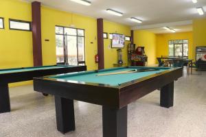 a pool table in a room with yellow walls at Valbom by Campigir in Sesimbra