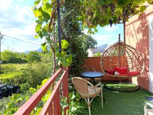 a balcony with a swing and a table and chairs at Green Valley GV in Kotor