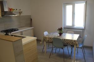 a kitchen with a table with chairs and a table and a window at APPARTAMENTO TORRESI 2 in Ancona +76 photos