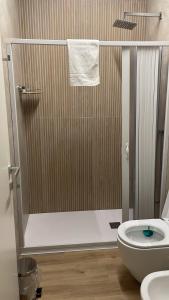 a bathroom with a shower with a toilet and a sink at Solea Home in Termoli +1 photo
