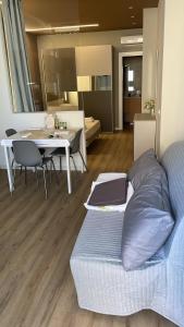 a living room with a bed and a table with chairs at Solea Home in Termoli