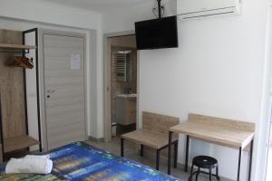a bedroom with a bed and a desk and a table at APPARTAMENTO TORRESI 2 in Ancona