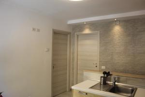 a kitchen with a sink and a counter top at APPARTAMENTO TORRESI 2 in Ancona