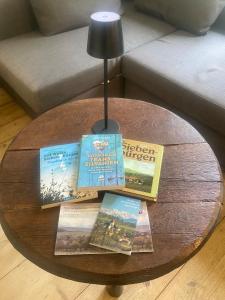 a round table with books on it with a lamp at Bavaria One in Cincu