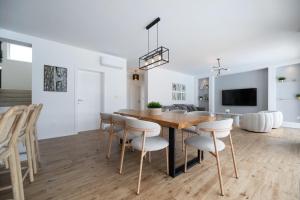 a kitchen and dining room with a wooden table and chairs at Vila Matak in Ražanac