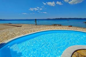 a swimming pool with a view of the ocean at SeaHouse Pakoštane - Hobby in Pakoštane