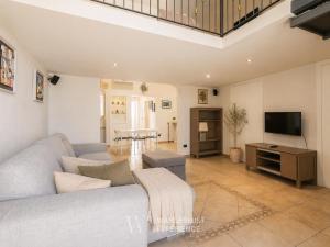 a living room with a couch and a tv at Wanderlust Experience Fronte Porto in Bari