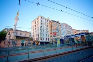 a city street with tall buildings and a train station at The Central Hotel in Istanbul