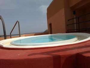a large jacuzzi tub sitting in a room at Apartamento Playasol in Vícar +11 photos