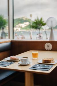 a table with a plate of food and a cup of coffee at Hotel Niza in San Sebastián