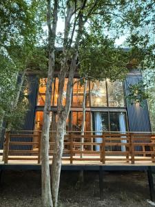 a house with a tree in front of it at Cabañas Mountain Fox in Puerto Varas