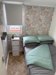a small bedroom with a bed and a window at The View in Leysdown-on-Sea