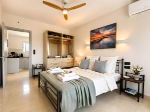 a bedroom with a bed with two towels on it at Nina Apartment in Ágios Márkos