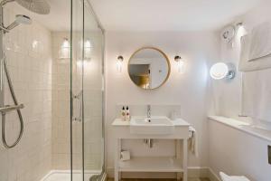 a white bathroom with a sink and a shower at Cub Bedroom Six in Eastdean
