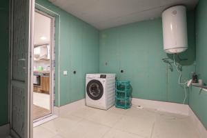 a laundry room with a washing machine in it at Girgola in Mestia