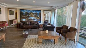 a living room with a couch and a table at Villa di Cavi Hotel in Gramado