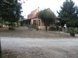 an old brick house with a picnic table in front of it at Douceur Meyralaise in Meyrals +4 photos