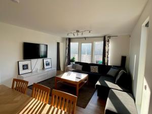 a living room with a couch and a table at Hällestrand Village in Strömstad