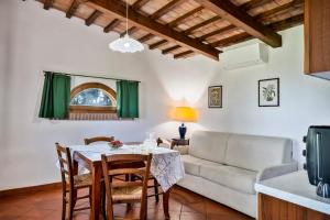 a living room with a table and a couch at Il Martellino in Follonica