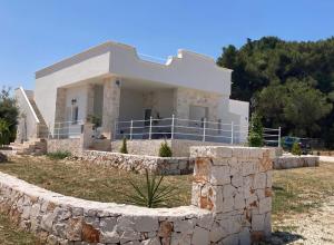 a house with a stone wall in front of it at Tra Cielo e Mare - Monopoli in Impalata