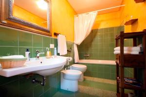a bathroom with a sink and a toilet and a tub at Antica Corte delle Ninfee, Historical Private Villa in Trapani +117 photos